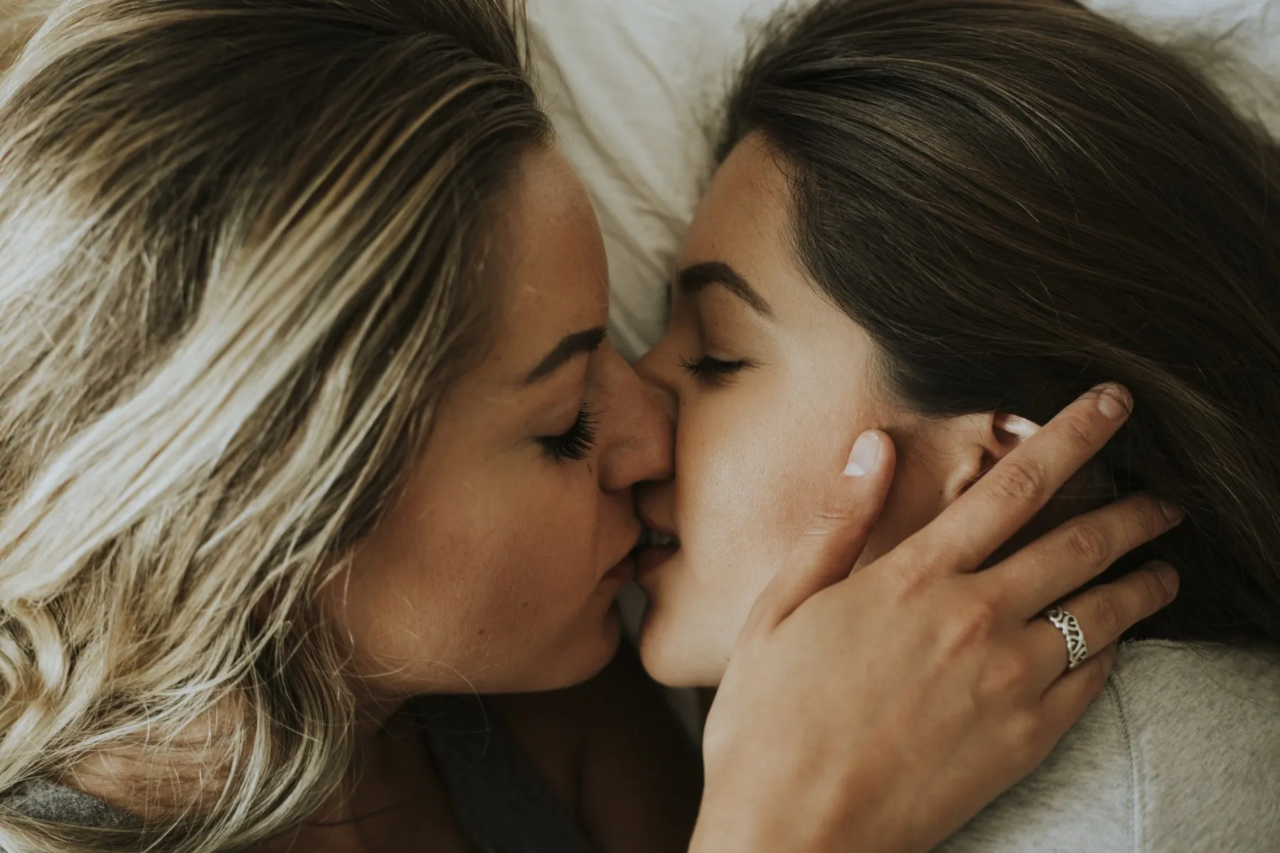 Two women kissing each other lovingly