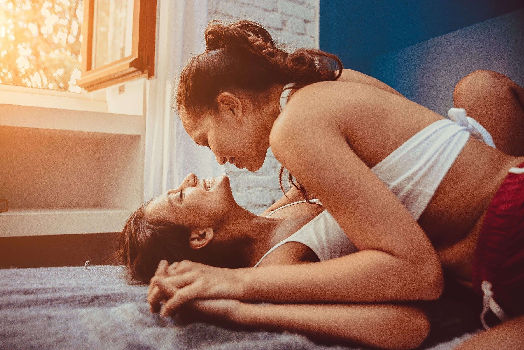 Two women having an intimate moment in bed