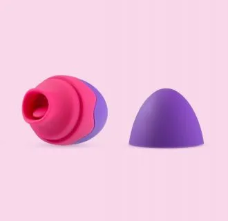 small purple and pink tongue flutter toy against a pink background